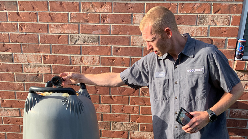 Technician checking filter pressure relief valve